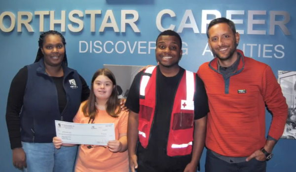 Career Academy presents a check to a representative of Red Cross